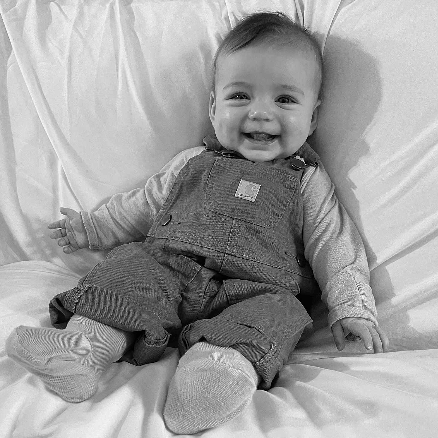Elladeigh joined the competition — help win amazing prizes! baby, smiling, infant, overalls, socks, bed, blanket, happy, portrait, monochrome, child, cute, clothing, person, face, sitting, cozy, relaxed, indoors, young