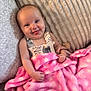 Emerson Rae is registered to the contest to win money with this photo: baby, blanket, clothing, couch, cushion, cute, face, furniture, happy, home, indoors, infant, person, pink, playful, portrait, resting, smile, toddler, wearing