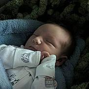 Ryder joined the competition — help win amazing prizes! baby, newborn, sleeping, blanket, onesie, infant, face, hand, cozy, soft, cute, animal_print, house_print, texture, green, blue, portrait, peaceful, rest, indoors