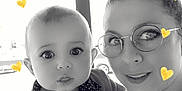 Ethan participe au concours pour gagner de l'argent avec cette photo : baby, black_and_white, cute, eyewear, face, family, glasses, hand, head, heart, indoor, jacket, light, love, people, polka_dot, portrait, smile, window, woman