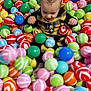 Ethan participe au concours pour gagner de l'argent avec cette photo : baby, ball_pit, blue, child, clothing, colorful, cute, fun, green, happy, indoor, joyful, net, orange, pink, play, red, smiling, striped_balls, yellow