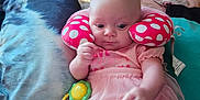 Willow joined the competition — help win amazing prizes! baby, bed, blanket, child, colorful, comfort, curious, cushion, cute, home, indoor, infant, lying_down, neck_pillow, person, pink_clothing, polka_dots, soft_toys, toy, tutu_skirt