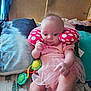 baby, bed, blanket, child, colorful, comfort, curious, cushion, cute, home, indoor, infant, lying_down, neck_pillow, person, pink_clothing, polka_dots, soft_toys, toy, tutu_skirt