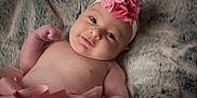 Emmy participe au concours pour gagner de l'argent avec cette photo : baby, infant, headband, pink, flower, blanket, fur, soft_texture, cute, smile, skin, newborn, tutu, clothing, portrait, lying_down, child, young, adorable, baby_girl
