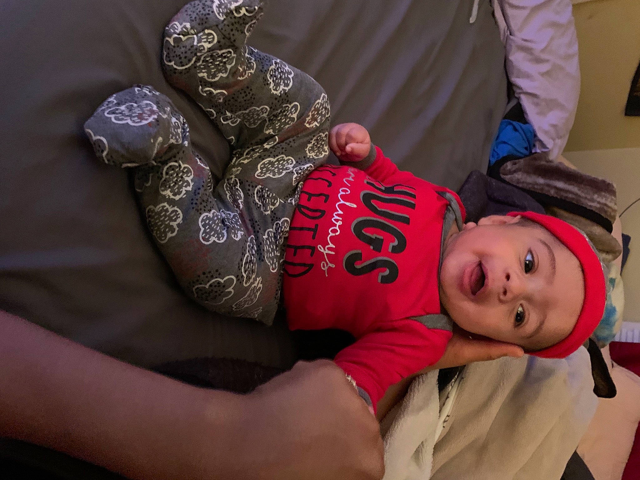 Joziah is registered to the contest to win money with this photo: abdomen, baby, baby_toddler_clothing, child, curtain, elbow, gesture, happy, hat, headwear, human_body, jewellery, magenta, nail, pattern, person, sleeve, smile, t_shirt, toddler