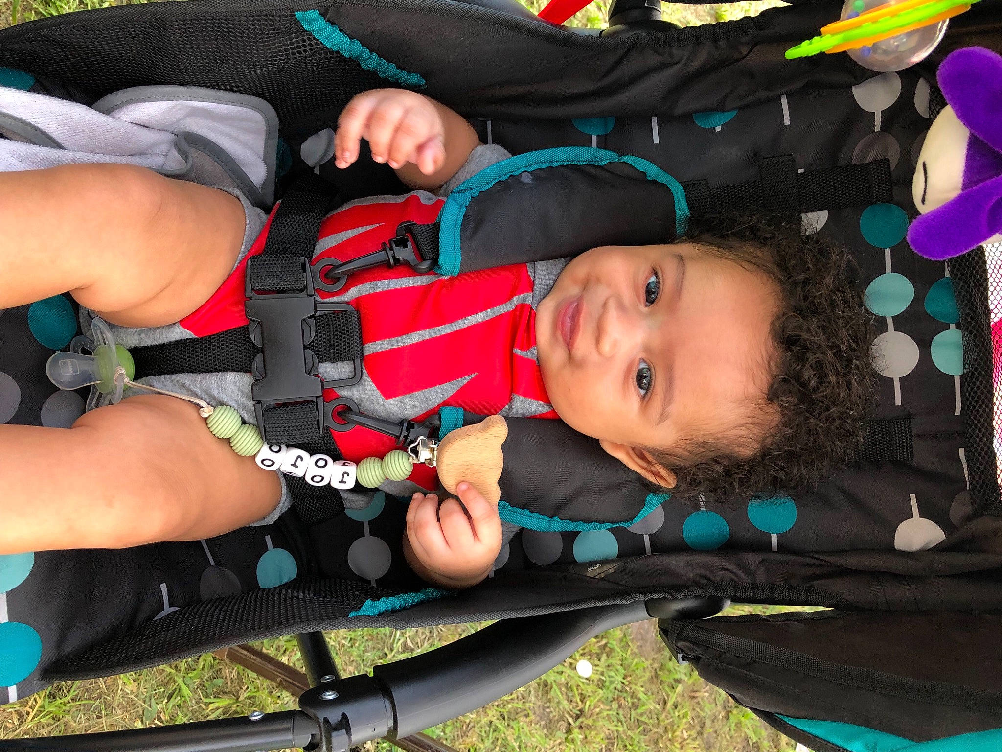 Joziah is registered to the contest to win money with this photo: baby, baby_products, baby_toddler_clothing, balloon, child, elbow, fun, grass, human_leg, lap, leisure, pattern, person, personal_protective_equipment, recreation, thigh, toddler, tree, wrist