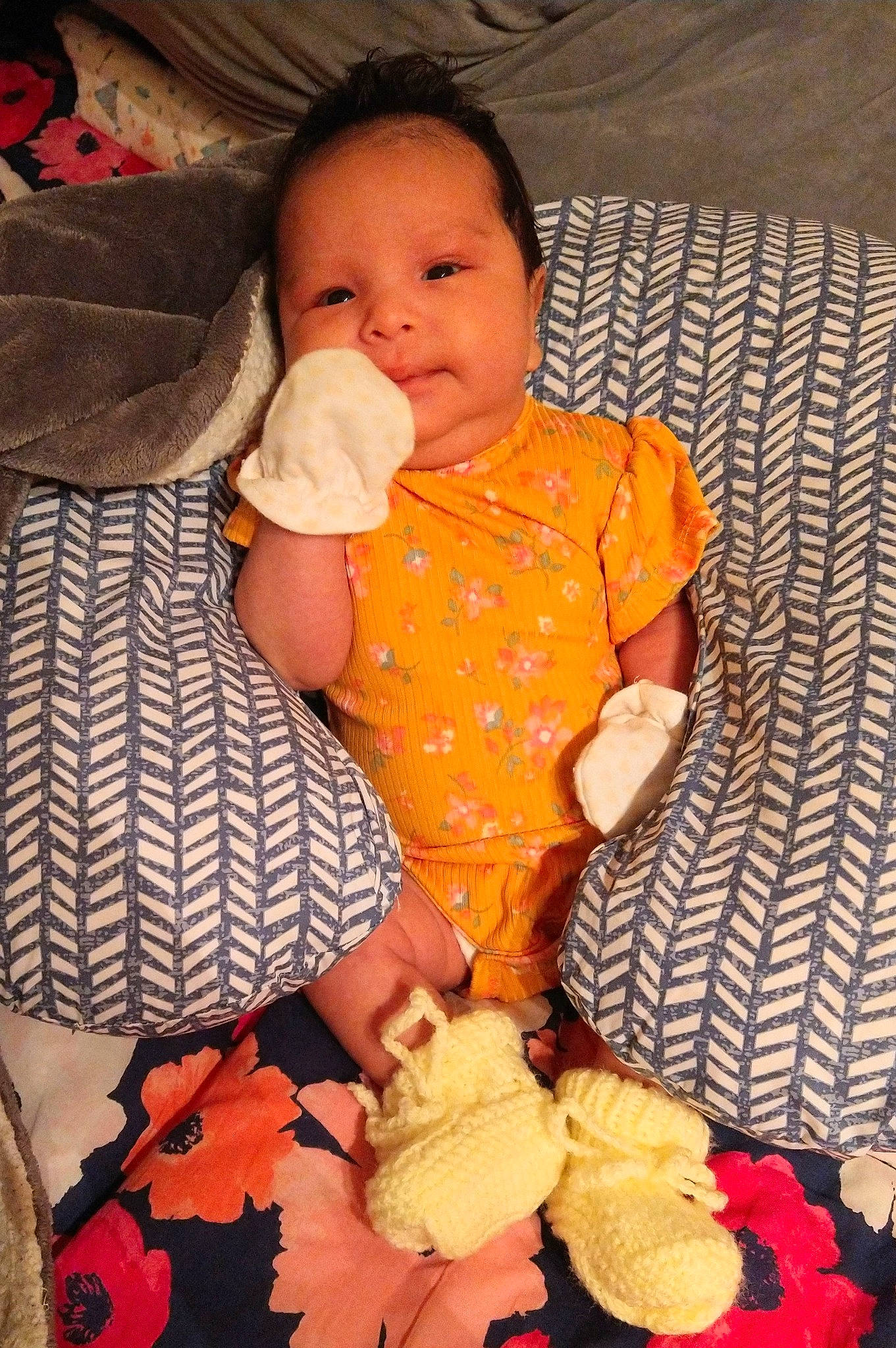 Yaretzi Eloisa is registered to the contest to win money with this photo: baby, baby_toddler_clothing, cheek, child, comfort, finger, happy, head, lap, linens, mouth, nose, orange, organ, pattern, person, sitting, skin, sleeve, textile