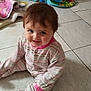 Mia participe au concours pour gagner de l'argent avec cette photo : baby, blanket, child, cute, face, floor, happy, head, home, indoor, infant, pajamas, person, playtime, sitting, smiling, striped_clothing, tile_floor, toys, young_child