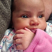 Nezuko joined the competition — help win amazing prizes! baby, infant, face, hand, pink_sleeve, clothing, onesie, closeup, portrait, cute, skin, eyes, fingers, texture, fabric, soft, child, newborn, person, indoors