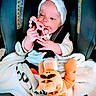 Madison is registered to the contest to win money with this photo: baby, child, car_seat, headband, teething_toy, blanket, plush_toy, tiger, infant, cute, indoors, seatbelt, child_safety, soft_toy, clothing, person, young_child, hands, face, comfort