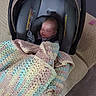 armrest, baby, blanket, car_seat, carpet, closed_eyes, couch, cozy, crocheted_blanket, fabric, face, head, indoor, infant, newborn, pastel_colors, peaceful, portrait, seat_belt, sleeping