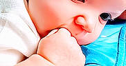 Madison is registered to the contest to win money with this photo: baby, baby_clothing, blue_blanket, child, closeup, cute, expression, face, fist, hand, head, indoor, infant, person, portrait, resting, skin, soft_lighting, sucking, young_child