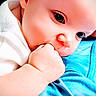 baby, baby_clothing, blue_blanket, child, closeup, cute, expression, face, fist, hand, head, indoor, infant, person, portrait, resting, skin, soft_lighting, sucking, young_child