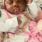 Blessyn Wingba is registered to the contest to win money with this photo: baby, sleeping, pajamas, headband, blanket, plush_toy, infant, cute, peaceful, cozy, pink, white_clothing, child, closeup, portrait, soft, indoor, resting, newborn, comfort
