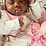 baby, sleeping, pajamas, headband, blanket, plush_toy, infant, cute, peaceful, cozy, pink, white_clothing, child, closeup, portrait, soft, indoor, resting, newborn, comfort