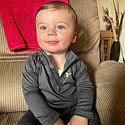 Colton is registered to the contest to win money with this photo: architecture, baby, bodypart, building, clothing, couch, cushion, face, furniture, head, homedecor, indoors, interiordesign, livingroom, pants, person, photography, portrait, room, sitting