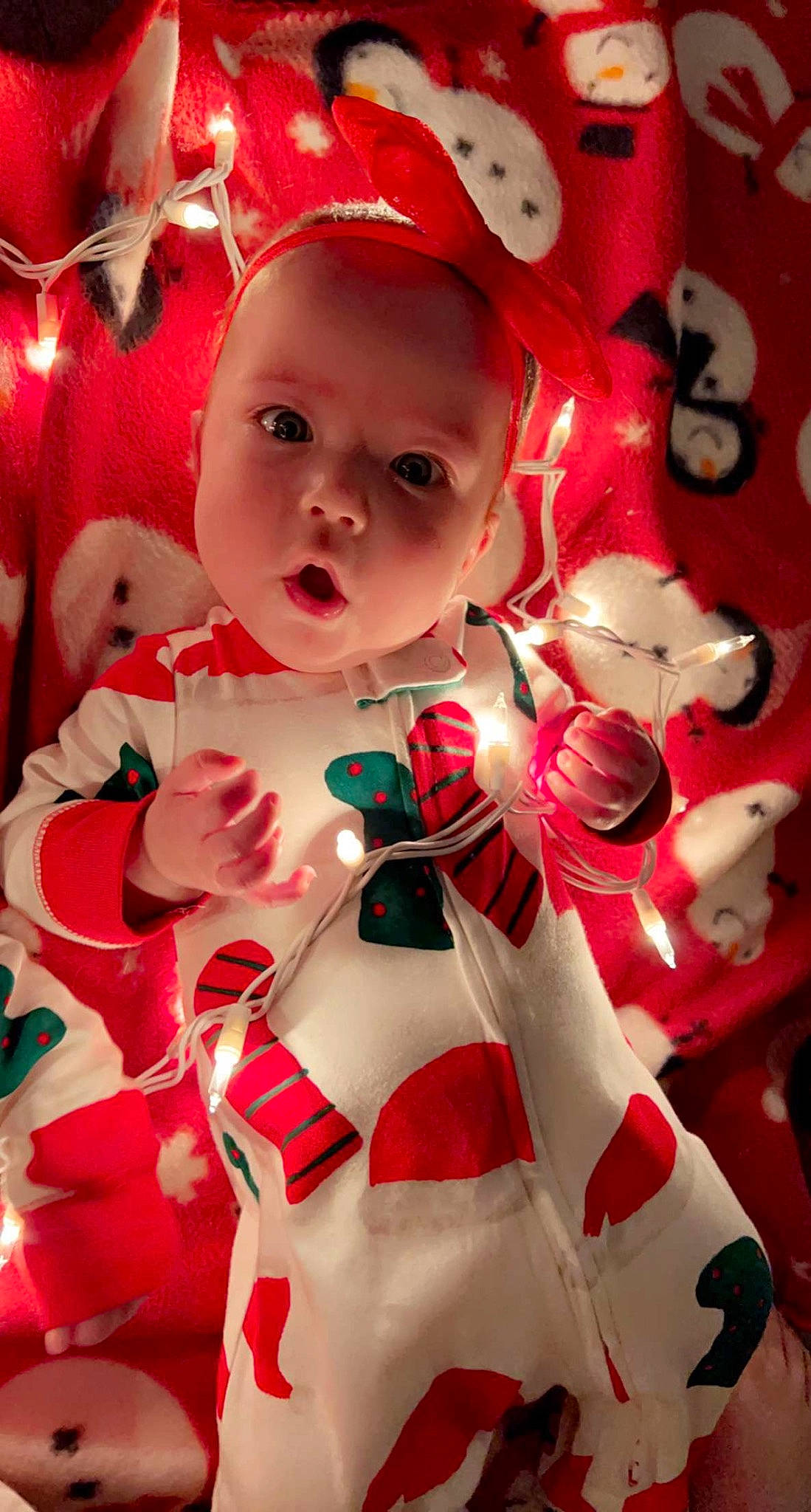 Delilah joined the competition — help win amazing prizes! baby, baby_toddler_clothing, cap, carmine, christmas, christmas_decoration, christmas_ornament, costume_hat, event, fictional_character, happy, hat, holiday, ornament, pattern, person, pink, red, santa_claus, toddler