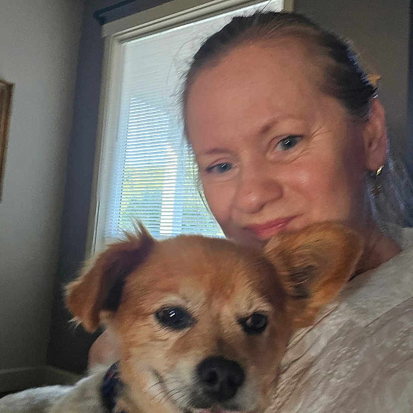 Rocky is registered to the contest to win money with this photo: animal, blond, casual, collar, companionship, cute, dog, earrings, face, friendship, home, human, indoor, light, pet, portrait, short_hair, smile, window, woman