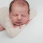 Hugo participe au concours pour gagner de l'argent avec cette photo : newborn, baby, sleeping, infant, knitwear, cream_color, soft_texture, peaceful, portrait, closeup, child, resting, cute, small_hands, head, face, closed_eyes, cozy, white_background, studio_photo