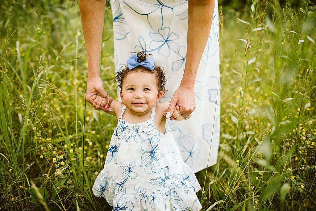 Gemma is registered to the contest to win money with this photo: baby, baby_toddler_clothing, child, clothing, dress, facial_expression, flash_photography, gesture, grass, grassland, hand, happy, joy, meadow, people, people_in_nature, person, plant, summer, sunlight