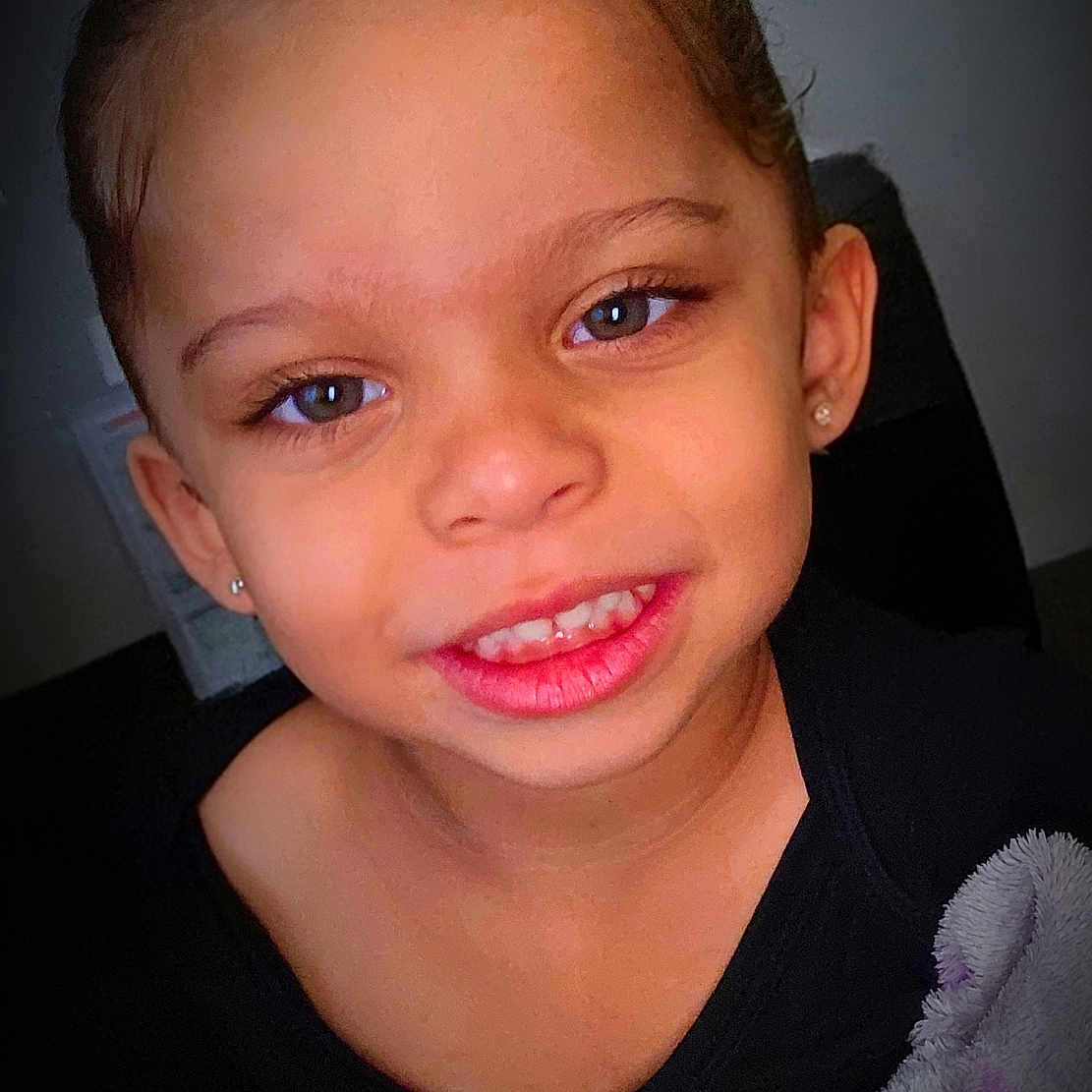 Aelia joined the competition — help win amazing prizes! black_clothing, blanket, child, closeup, cute, earrings, eyes, face, hair, hands, happy, head, holding, indoor, person, portrait, skin, smiling, toy, young