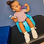 Aelia is registered to the contest to win money with this photo: toddler, child, baby_seat, toothbrush, toothpaste, shoes, socks, purple_shirt, blue_wall, black_surface, curly_hair, indoor, person, brushing_teeth, cute, focused, seated, small_hands, young_child, healthcare