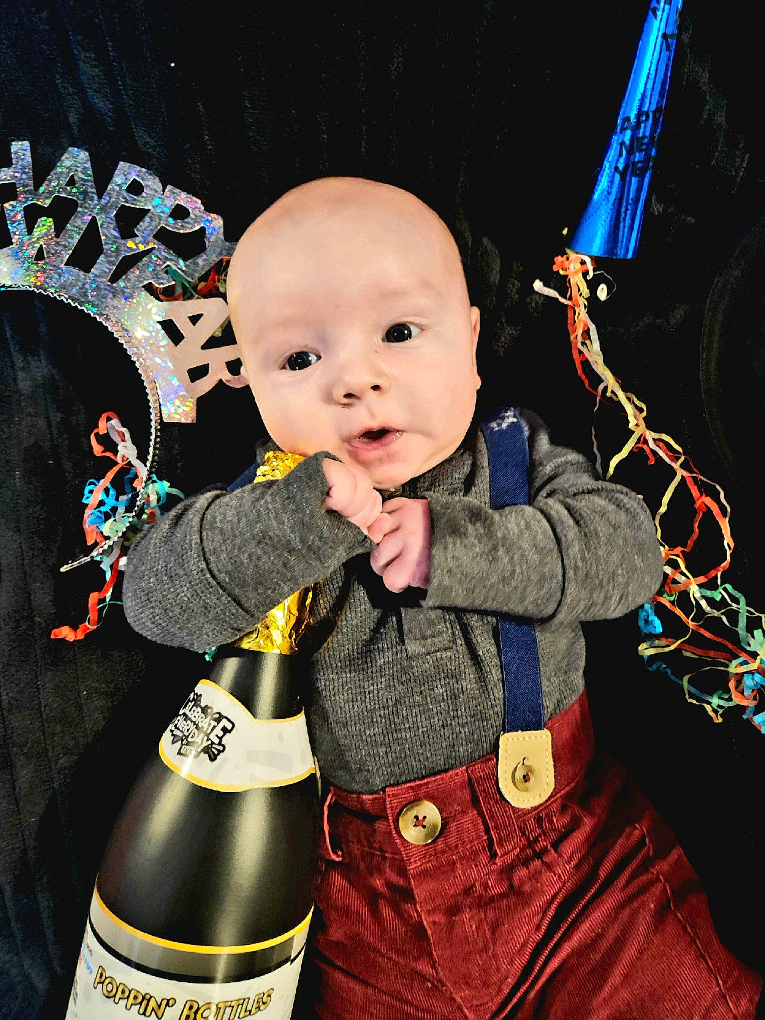 Phoenix is registered to the contest to win money with this photo: baby, baby_products, baby_toddler_clothing, bottle, child, christmas_eve, costume, costume_hat, drink, event, fashion_accessory, fictional_character, formal_wear, fun, happy, pattern, person, product, sleeve, toddler