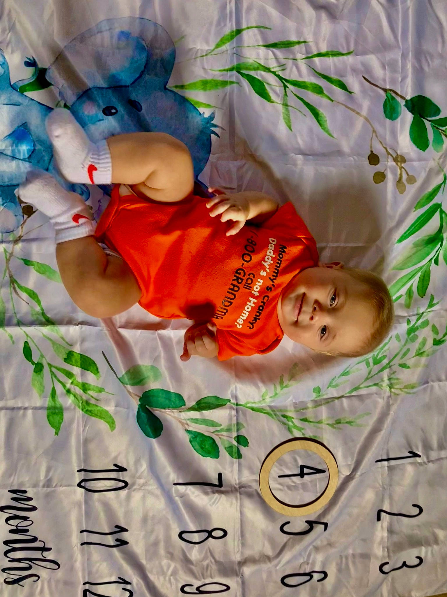 Kash is registered to the contest to win money with this photo: baby, baby_products, baby_toddler_clothing, child, comfort, event, font, fun, happy, joy, linens, orange, pattern, person, play, room, sleeve, smile, t_shirt, toddler