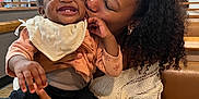 Rui joined the competition — help win amazing prizes! baby, woman, smile, kiss, curly_hair, indoor, restaurant, booth, table, clothing, bib, happy, person, affection, holding, casual_wear, skin, earrings, hair, joy