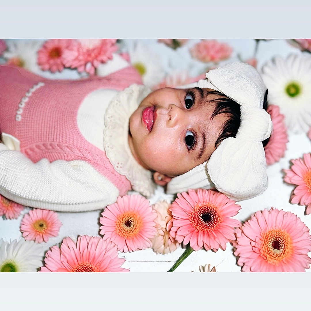 Anairaliz Marie is registered to the contest to win money with this photo: anemone, baby, bonnet, clothing, cushion, daisy, face, flower, flowerarrangement, flowerbouquet, happy, hat, head, newborn, person, petal, photography, plant, portrait, smile