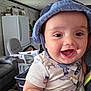 Grayson joined the competition — help win amazing prizes! baby, child, smiling, hat, indoor, face, happy, clothing, person, living_room, furniture, chair, refrigerator, household, cute, infant, portrait, toddler, cheerful, closeup