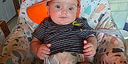 Grayson joined the competition — help win amazing prizes! baby, infant, cap, orange_cap, striped_shirt, baby_seat, patterned_seat, indoor, kitchen, furniture, plastic_bag, cabinet, door, person, child, face, hands, legs, curious, blue_eyes