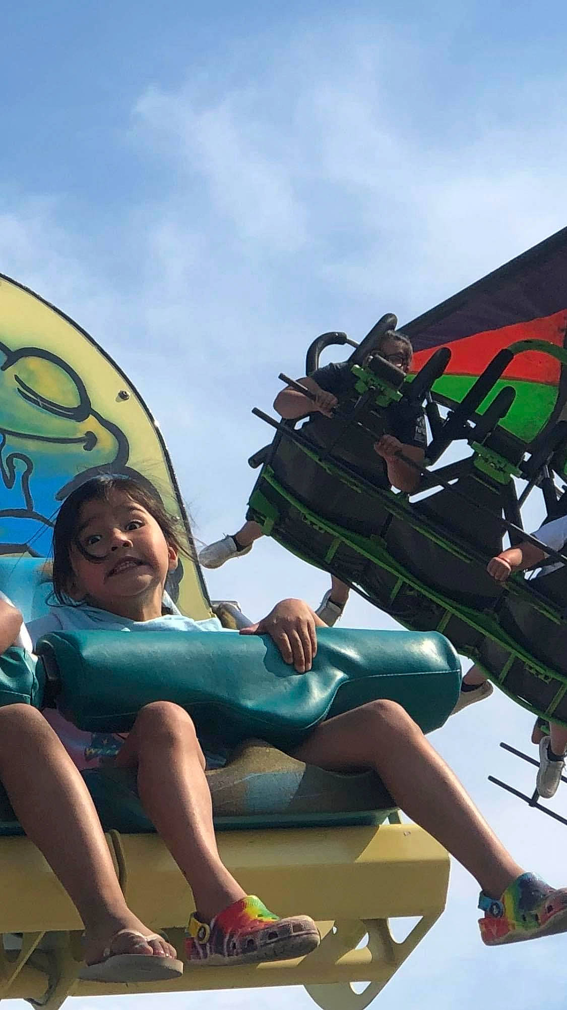 Justice joined the competition — help win amazing prizes! amusement_park, amusement_ride, cloud, foot, fun, happy, human_leg, leisure, nonbuilding_structure, person, recreation, sandal, shoe, shorts, sitting, sky, smile, thigh, tourism, travel