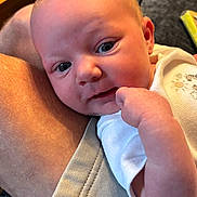 Cataleya is registered to the contest to win money with this photo: baby, infant, face, skin, hand, clothing, leg, person, closeup, indoor, expression, curious, resting, human, young_child, casual, fabric, comfort, portrait, soft