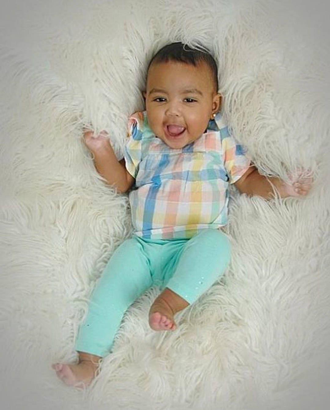 Cleigha is registered to the contest to win money with this photo: baby, baby_toddler_clothing, beauty, child, eye, facial_expression, happy, head, nose, person, photography, product, sitting, skin, sleeve, smile, toddler, turquoise, white