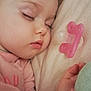 baby, sleeping, pacifier, pink, pillow, soft, hand, plush_toy, close_up, face, child, peaceful, indoor, infant, cute, portrait, relaxation, cozy, person, toddler