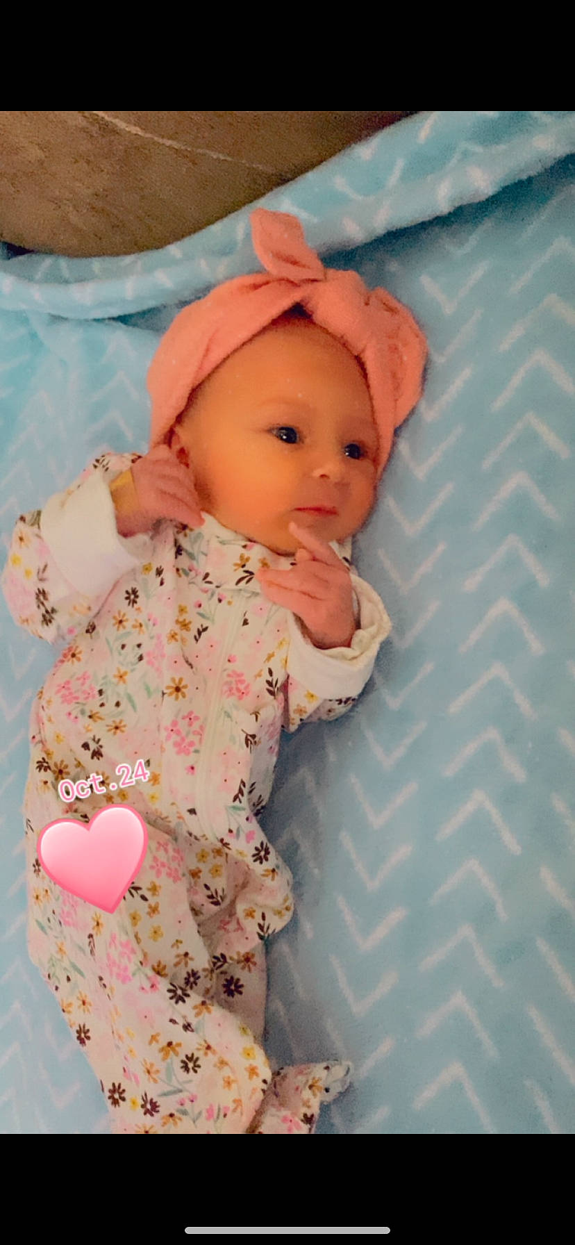 Kaya is registered to the contest to win money with this photo: baby, baby_products, baby_toddler_clothing, baby_toys, cap, cheek, child, comfort, doll, face, headwear, linens, outerwear, pattern, peach, person, pink, room, skin, sleeve