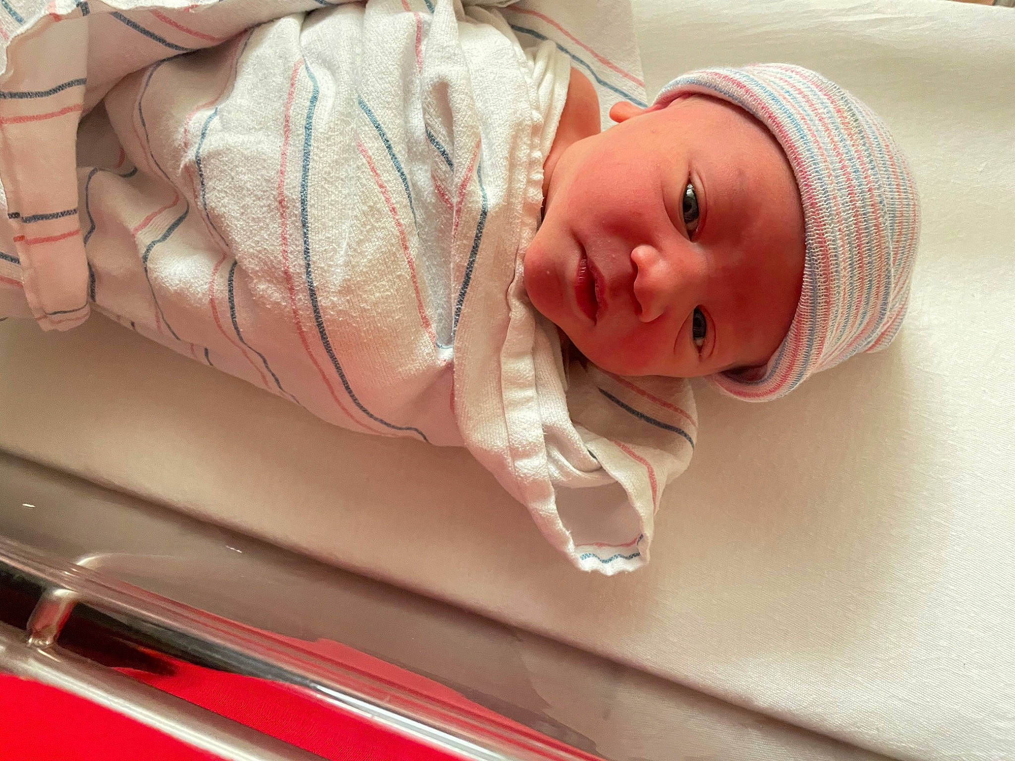 Damien is registered to the contest to win money with this photo: automotive_design, automotive_exterior, automotive_lighting, baby, baby_products, bumper, child, comfort, hat, headwear, hood, linens, luxury_vehicle, mid_size_car, motor_vehicle, person, personal_luxury_car, room, skin, toddler