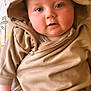 Koa joined the competition — help win amazing prizes! baby, child, hoodie, bear_ears, cute, infant, face, eyes, expression, couch, cushion, soft_lighting, cozy, casual_clothing, portrait, indoor, close_up, comfort, seated, adorable