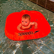 Koa joined the competition — help win amazing prizes! baby, infant, pool, water, inflatable_ring, swimming, child, floating, orange, speedo, tiled_wall, curious, wet_hair, summer, leisure, fun, cute, playful, splash, swimwear