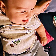 Elijah joined the competition — help win amazing prizes! baby, child, smiling, tongue_out, headband, floral, shirt, shorts, cushion, sofa, indoors, happy, person, cute, toddler, relaxing, comfort, playful, face, skin