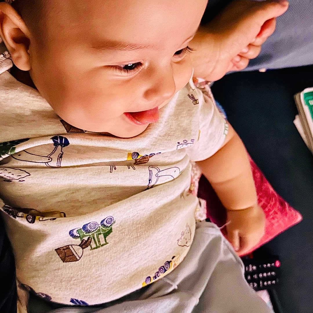 Elijah joined the competition — help win amazing prizes! baby, child, comfort, cushion, cute, face, floral, happy, headband, indoors, person, playful, relaxing, shirt, shorts, skin, smiling, sofa, toddler, tongue_out