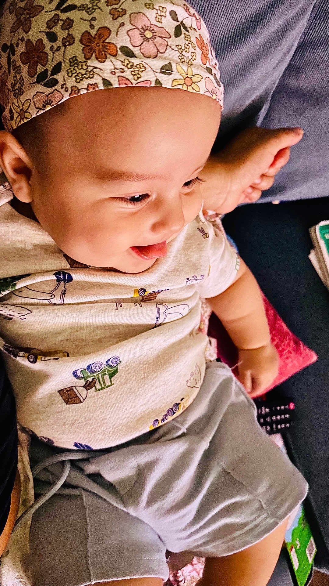 Elijah joined the competition — help win amazing prizes! baby, child, smiling, tongue_out, headband, floral, shirt, shorts, cushion, sofa, indoors, happy, person, cute, toddler, relaxing, comfort, playful, face, skin