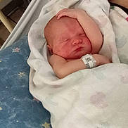 Harry joined the competition — help win amazing prizes! newborn, baby, infant, sleeping, hospital, bassinet, blanket, swaddled, face, portrait, closed_eyes, peaceful, wristband, medical, star_pattern, blue_blanket, indoors, caregiver, resting, adorable