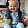 baby, child, smiling, hoodie, vest, sitting, indoor, blanket, soft_texture, cute, happy, person, infant, clothing, feet, sock, face, portrait, home, cozy