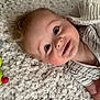 Maxson joined the competition — help win amazing prizes! baby, child, smiling, toy, carpet, blanket, striped_clothing, face, happy, infant, indoor, cute, young_child, person, lying_down, playtime, soft_texture, cozy, head, cheeks
