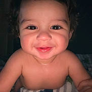 Mael joined the competition — help win amazing prizes! baby, child, smiling, curly_hair, blanket, striped_blanket, indoor, portrait, happy, cute, infant, face, skin, eyes, mouth, expression, toddler, young_child, person, closeup