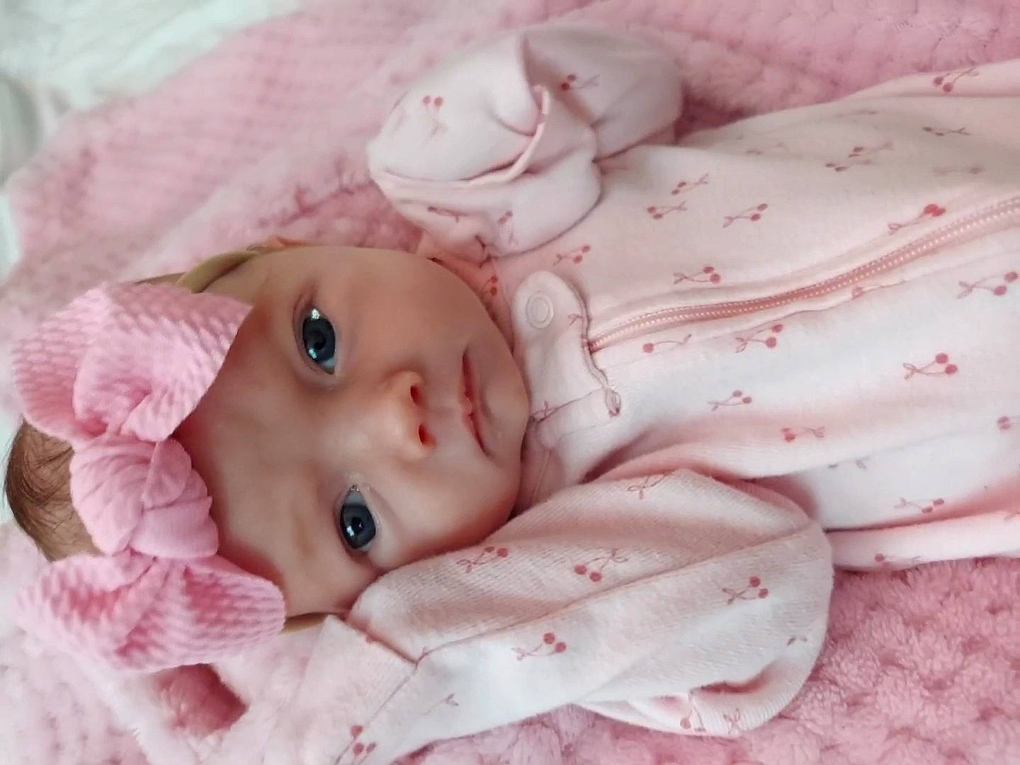 Leora is registered to the contest to win money with this photo: baby, baby_toddler_clothing, cheek, child, close_up, comfort, doll, eye, eyelash, head, headwear, iris, lip, pattern, peach, person, pink, skin, sleeve, textile