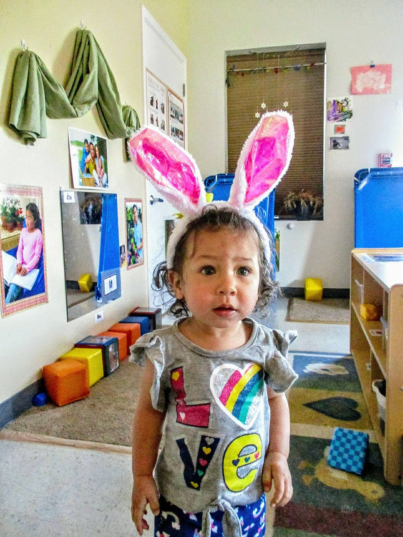 Kailani is registered to the contest to win money with this photo: baby, baby_toddler_clothing, blue, child, event, fun, happy, kindergarten, magenta, party, party_supply, person, play, room, school, shelf, shipping_box, stuffed_toy, t_shirt, toddler