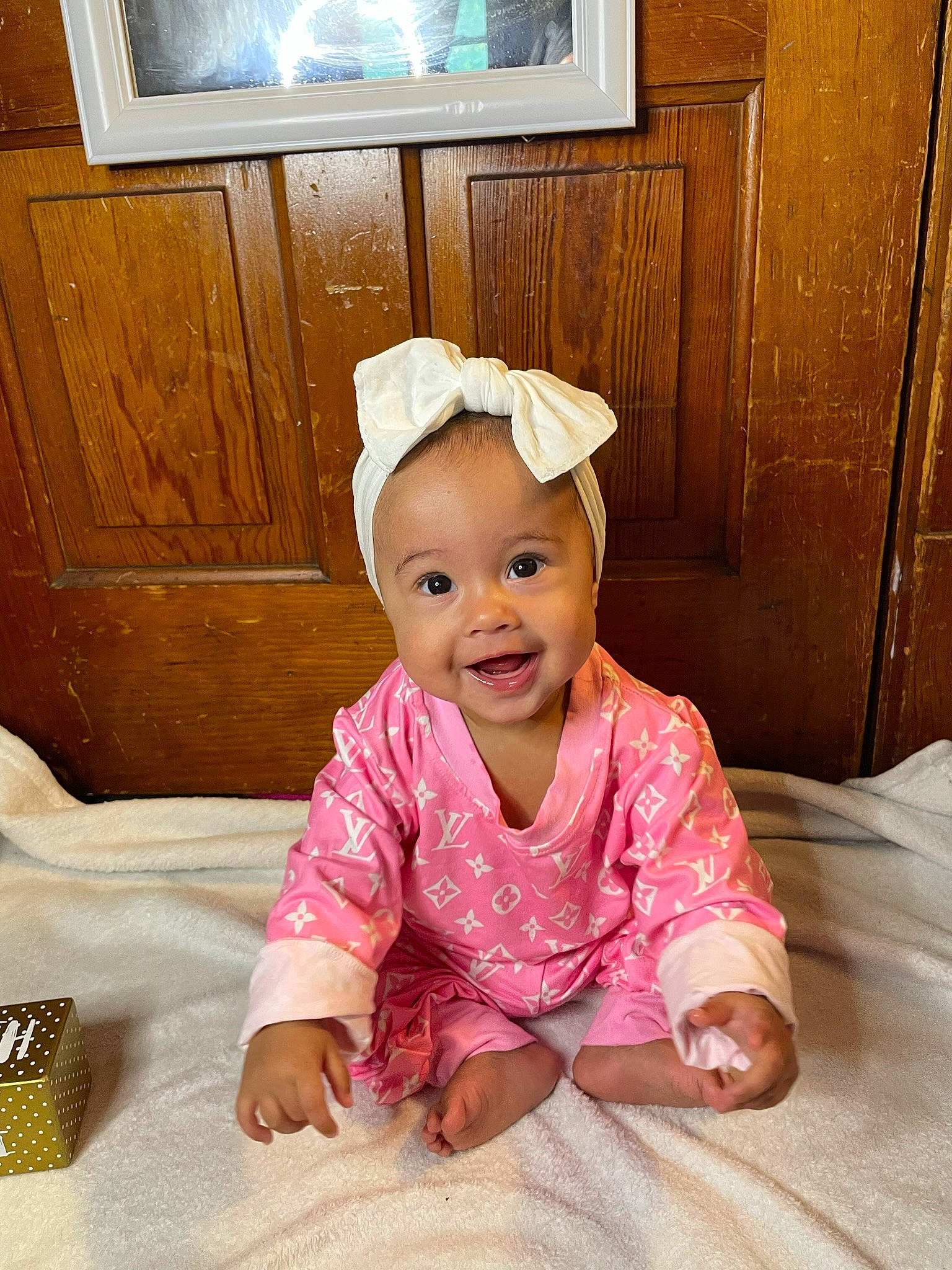 Azariah is registered to the contest to win money with this photo: baby, baby_toddler_clothing, cabinetry, child, comfort, crawling, floor, flooring, fun, happy, head, headgear, linens, mammal, person, pink, room, sleeve, smile, toddler